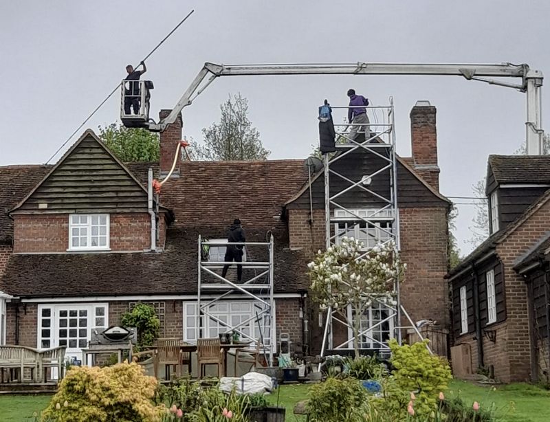 The Moss Cleaners using cherry picker and scaffolding to clean roof safely and professionally in Bursledon, Hampshire